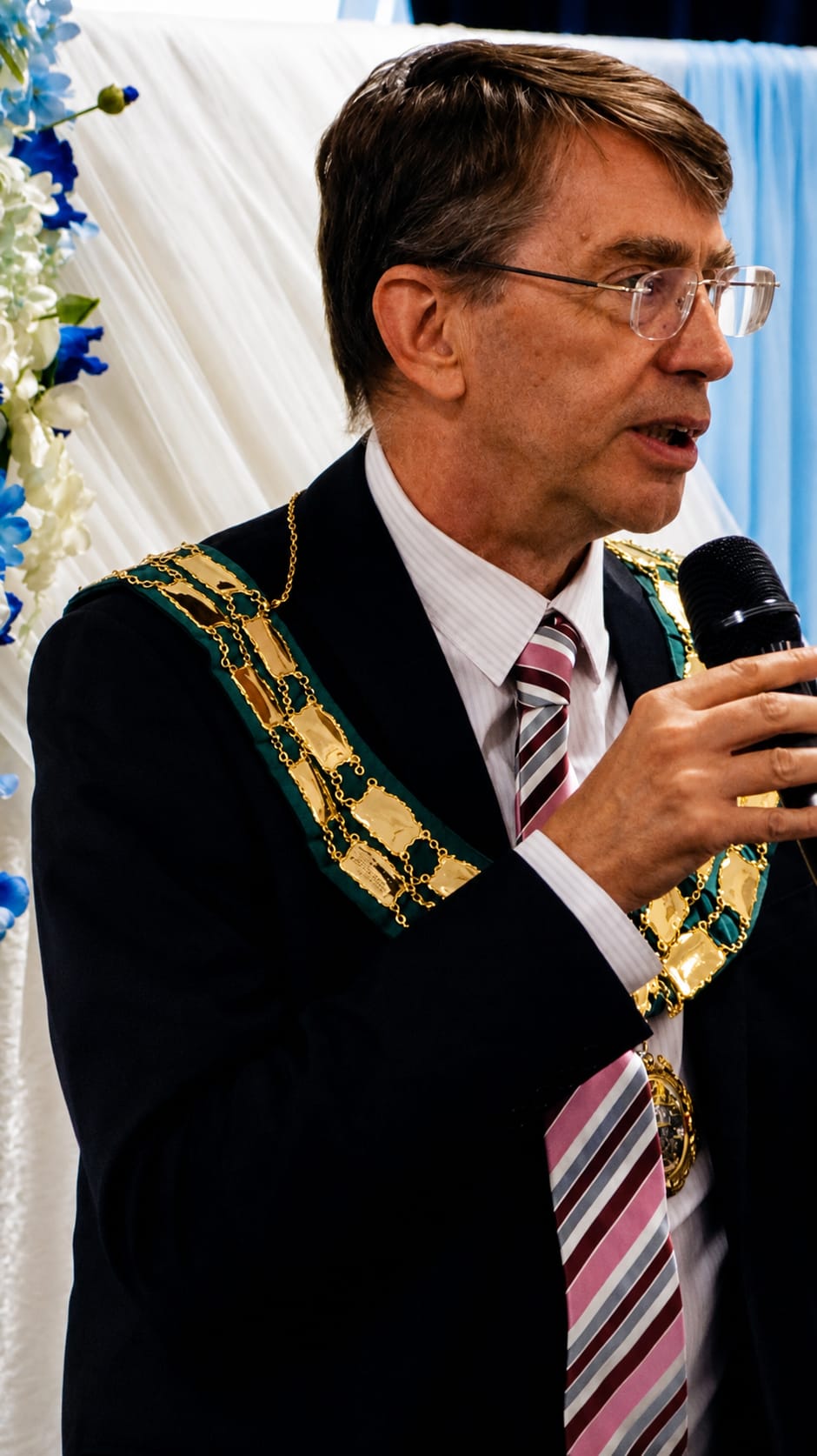 Mayor David Rouane, wearing his mayoral chain, giving a speech at the official launch of SEN Families Unite CIC.